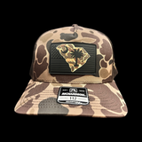 864 Richardson Brown Duck Camo Blackout Performance PVC Patch Trucker