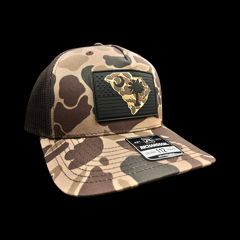 864 Richardson Brown Duck Camo Blackout Performance PVC Patch Trucker