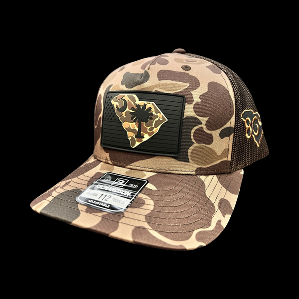 864 Richardson Brown Duck Camo Blackout Performance PVC Patch Trucker