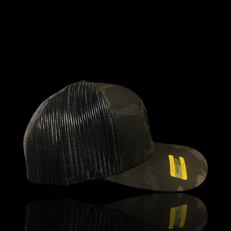 864 Yupoong Black Camo Trucker