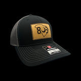 803 Richardson Black and Steel Genuine Leather Patch Trucker